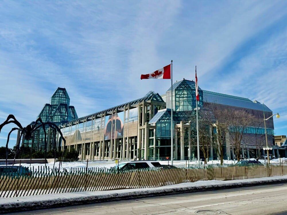 Exterior of the National Gallery of Canada building in winter with its spider sculpture in front