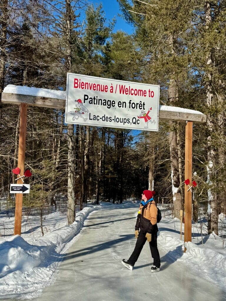 A woman poses in front of a skate trail entrance