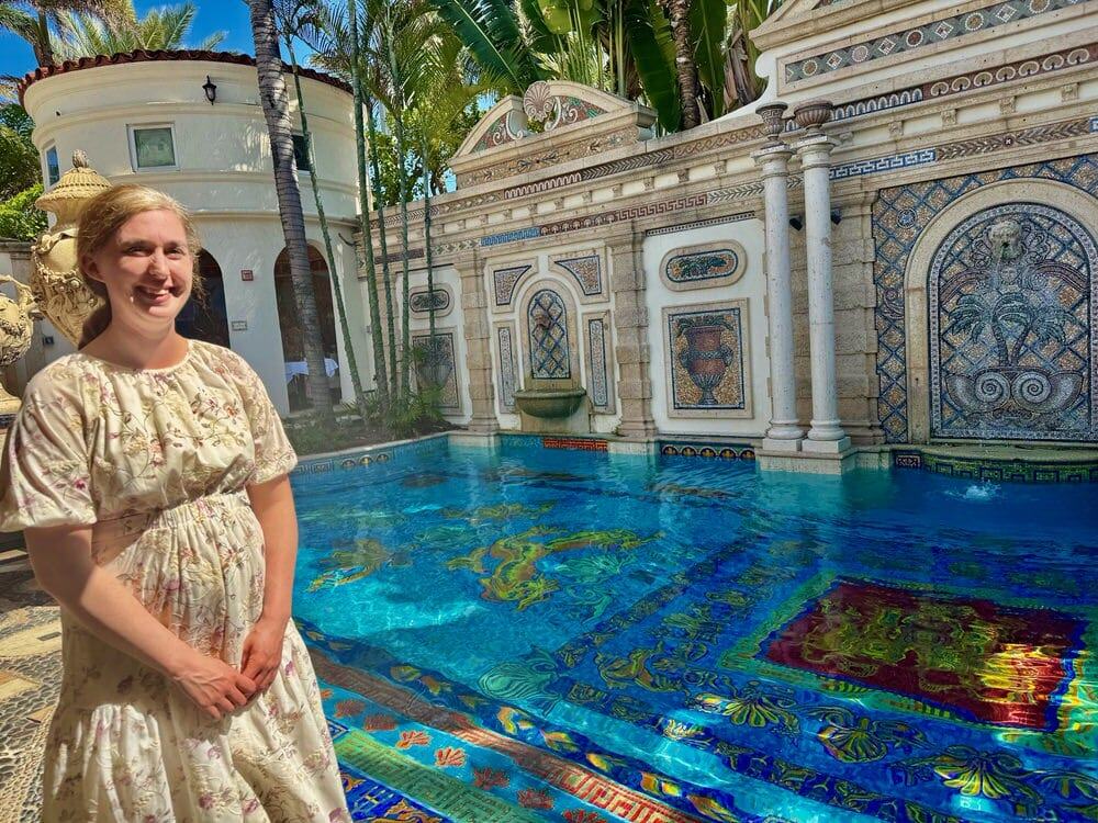 Woman stands in front an Italianite pool with a mosaic bottom in the Versace Mansion in Miami Beach, now an Italian restaurant