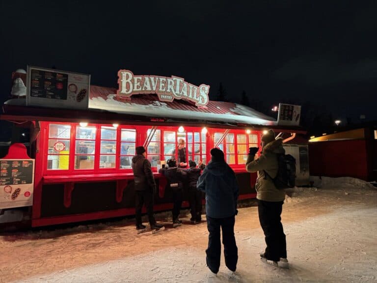 Skaters on the Rideau Canal Skateway in Ottawa wait to order at a Beavertail pastry stand