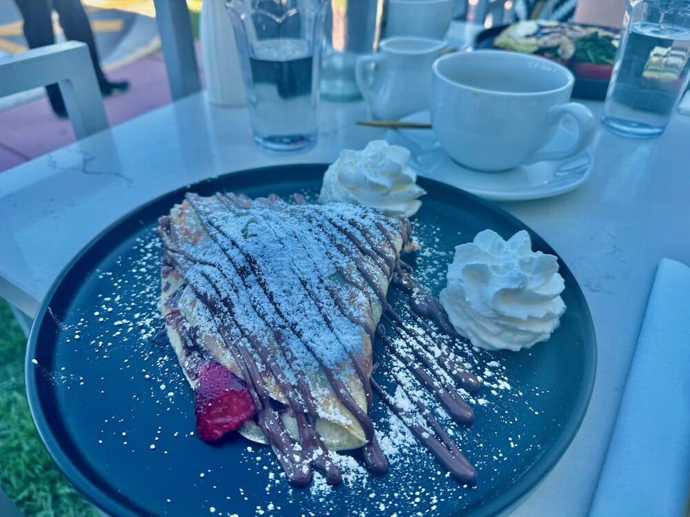 Strawberry and chocolate crepes on an outdoor brunch table at a Miami Beach restaurant