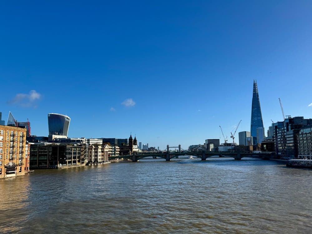 City view looking east down the Thames River into the city of London from the Millennium pedestrian bridge.