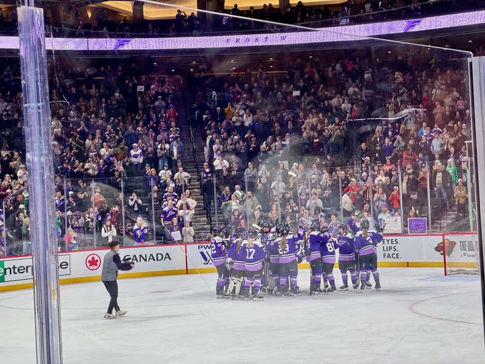 Professional women hockey players celebrate after a win in St. Paul