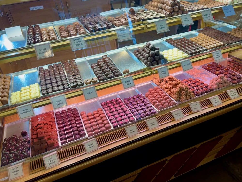 An assortment of chocolates and caramels line a glass display case in a York chocolate shop