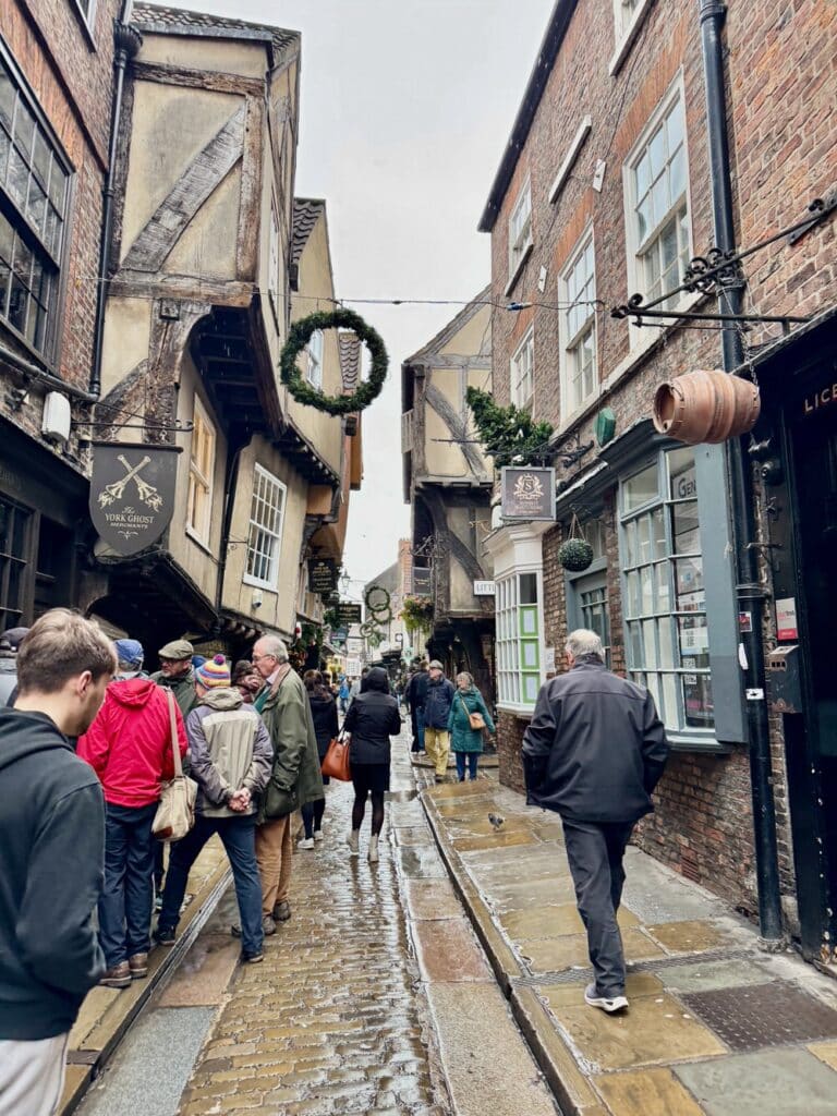 Shoppers mill outside of popular shops on the medieval Shambles street in York