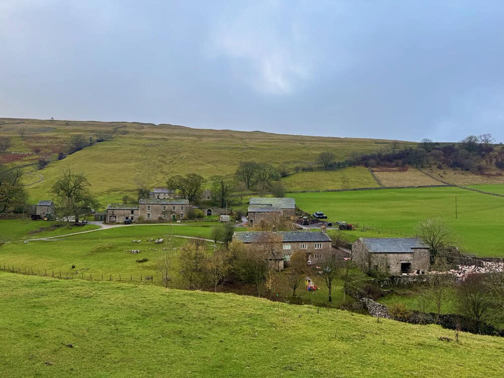 Picturesque Yorkshire Dales farm with stone buildings on an overcast day