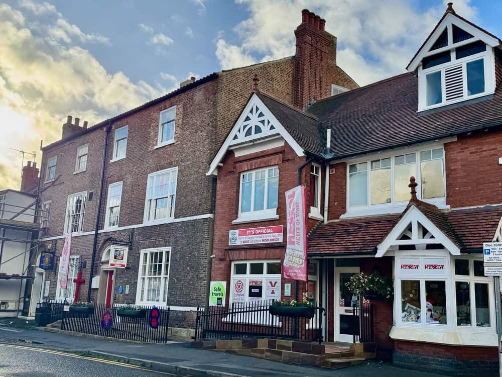 Two stone buildings in central Thirsk, Yorkshire that are now a museum devoted to the vet James Herriot