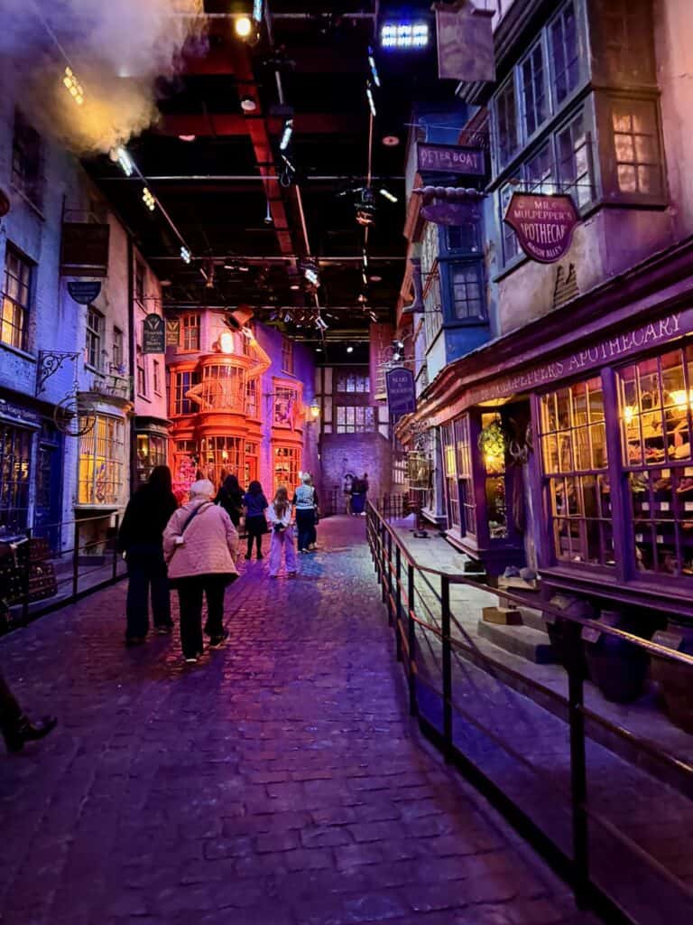 Visitors stroll through the Diagon Alley set in Warner Bros Studio Leavesden London