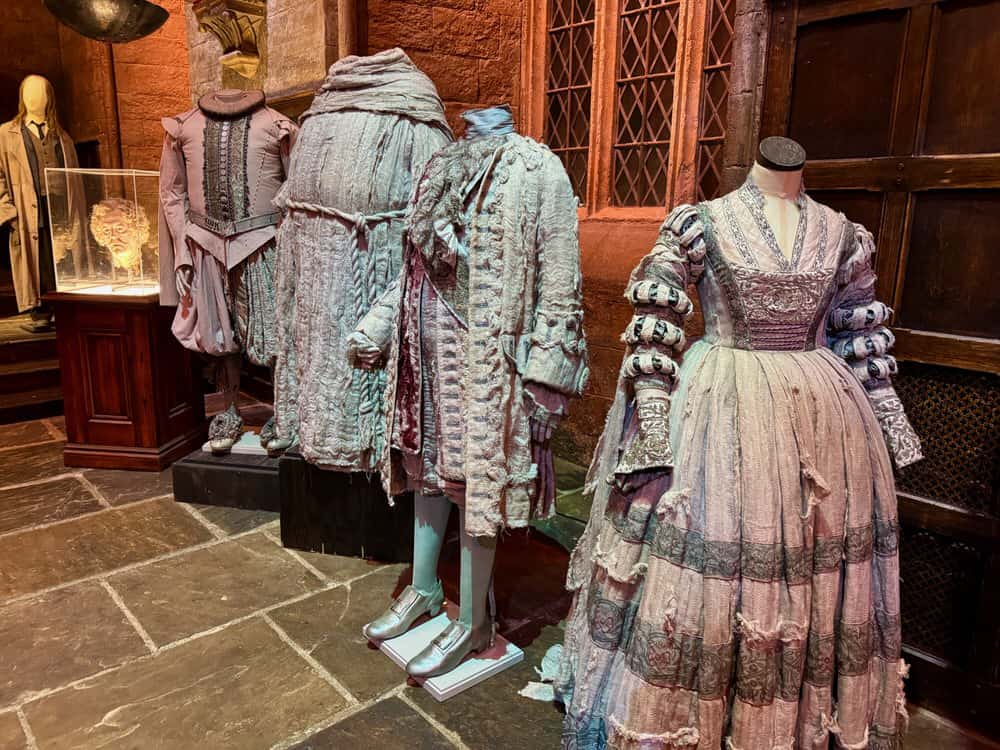Grey Renaissance era costumes on display in the Hogwarts Great Hall set of the Making of Harry Potter Tour