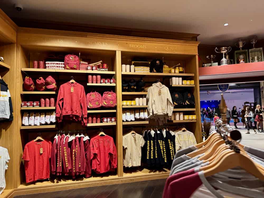Clothing, mugs, and other gift shop items branded with Gryffindor and Hufflepuff houses