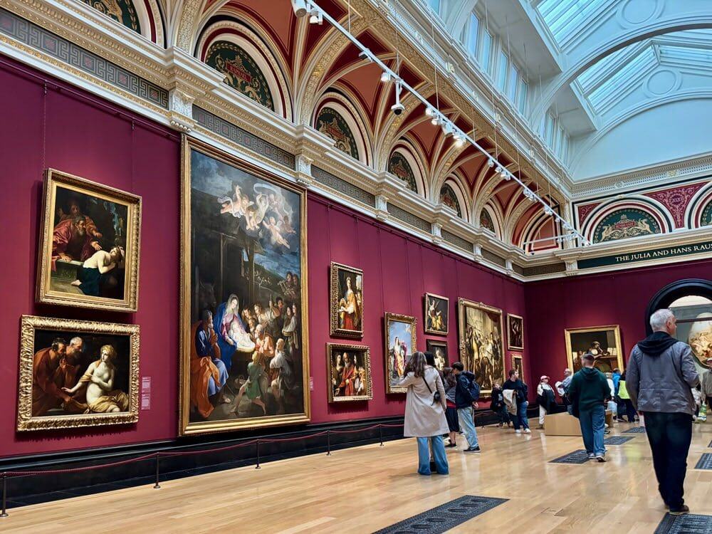 Visitors look at paintings inside the National Gallery, London