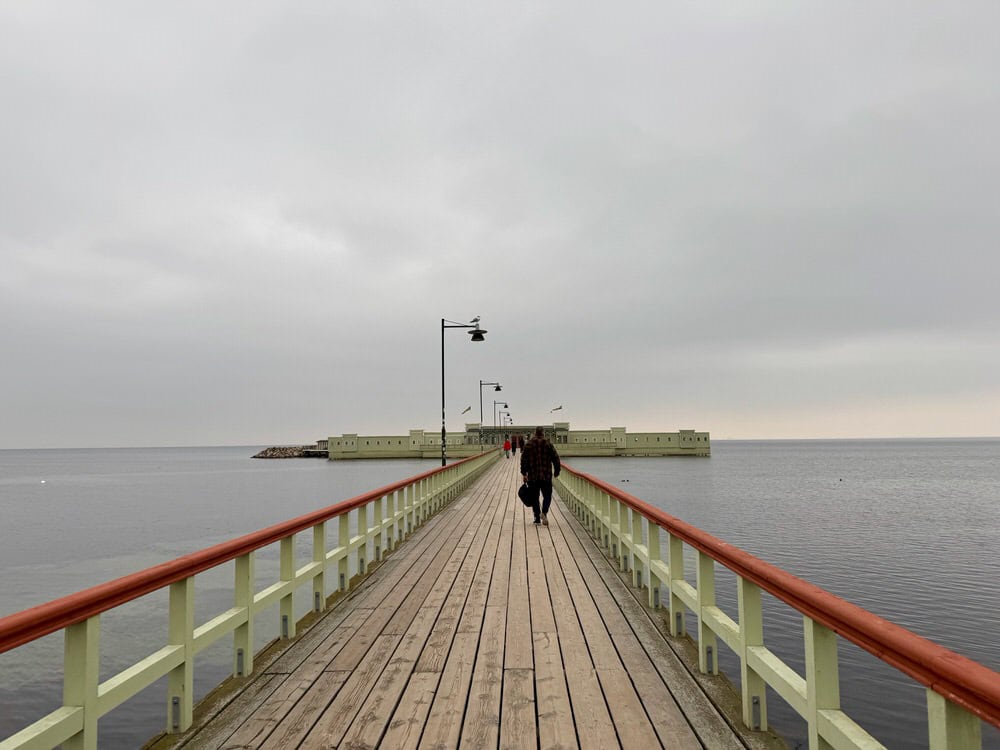 People walk on the causeway between Riberborgs beach and the kallbadhus facility in Malmo Sweden