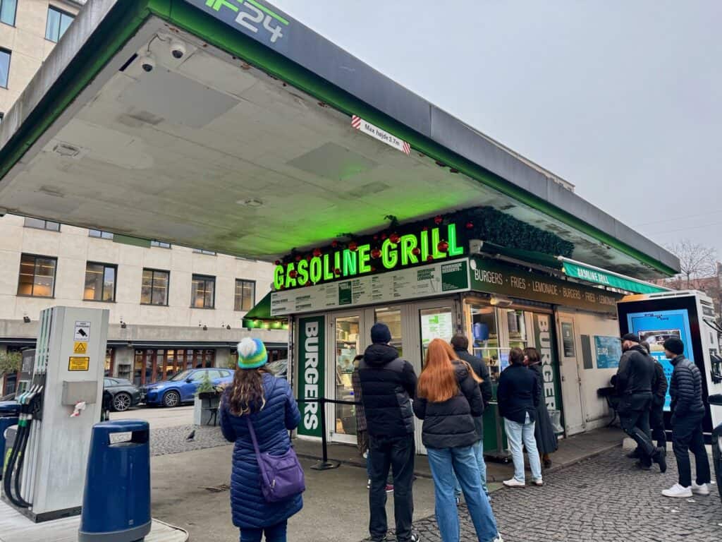 People queue in front of a fast food restaurant in a Copenhagen gas station.
