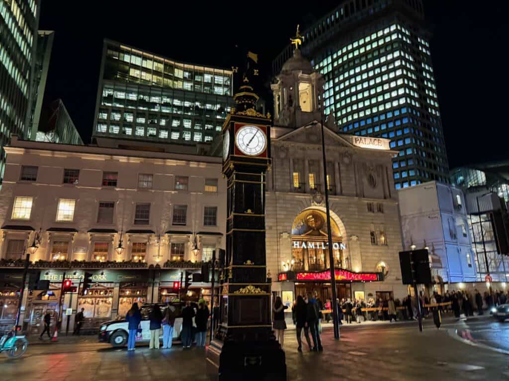 Black Victorian clock tower outside of the Palace Theatre in Victoria London after dark