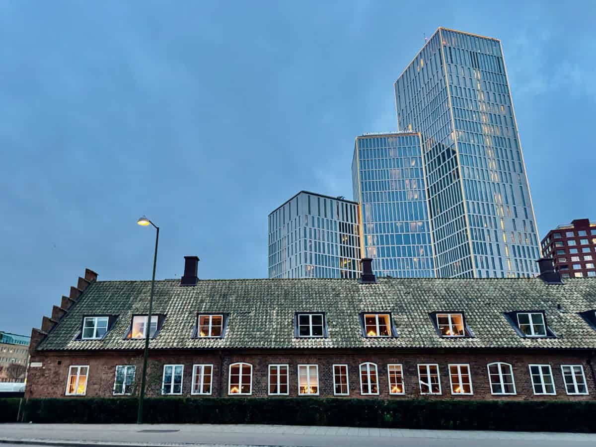 Modern skyscrapers rise behind a historic building in downtown Malmo Sweden