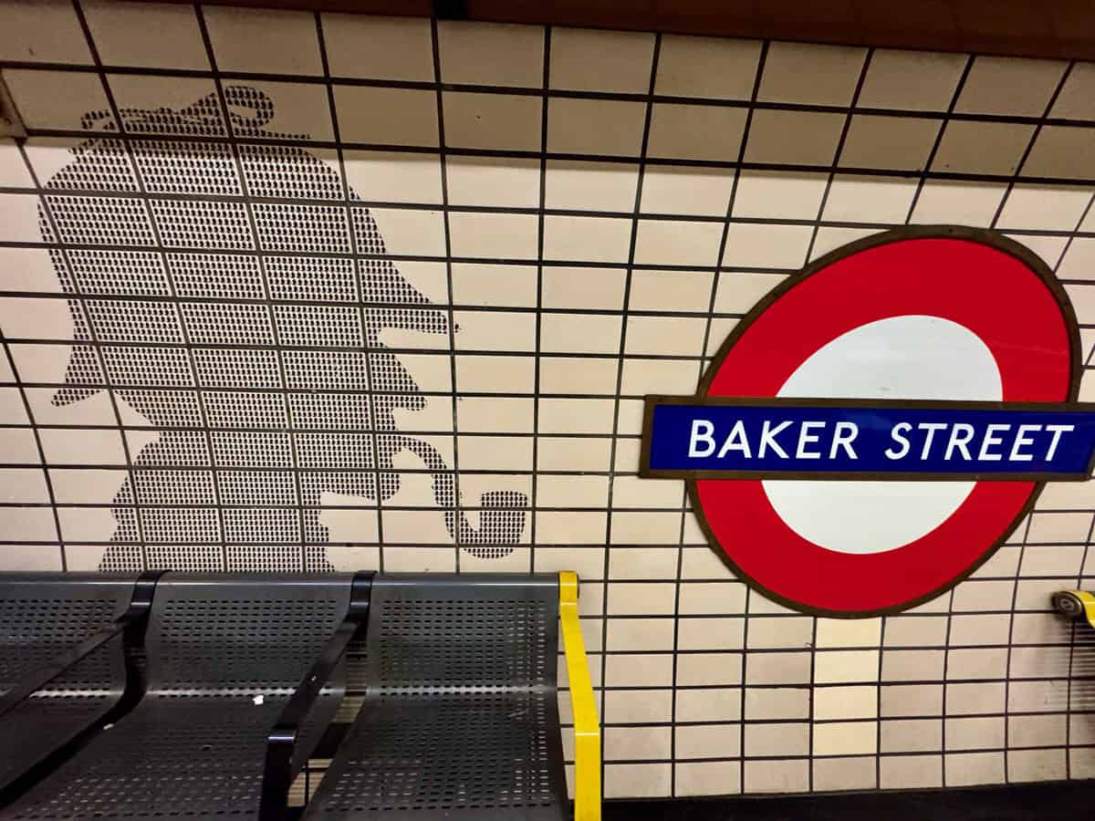 Sherlock Holmes silhouette on the tiles of a London tube station platform wall at Baker Street Station