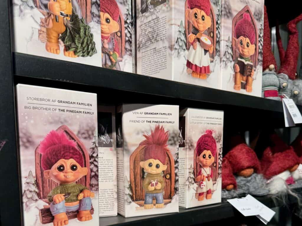 Boxes of Pinedam Family trolls on a Copenhagen gift shop shelf.