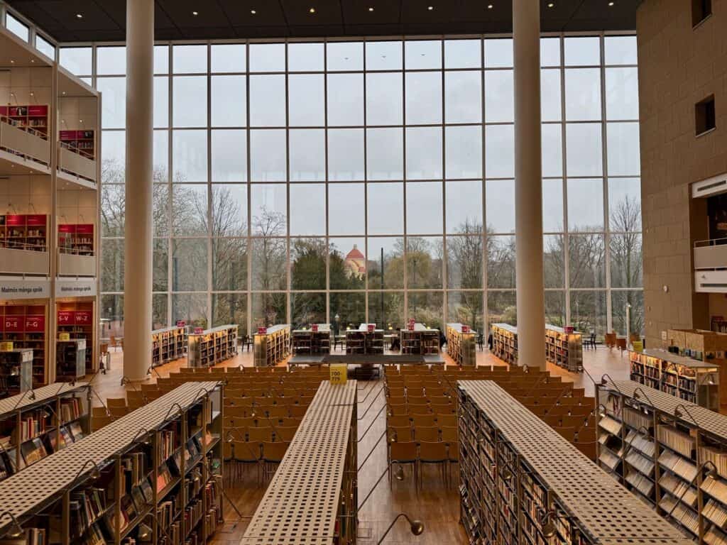 A wall of windows in Malmo Public Library looks out on the city park.