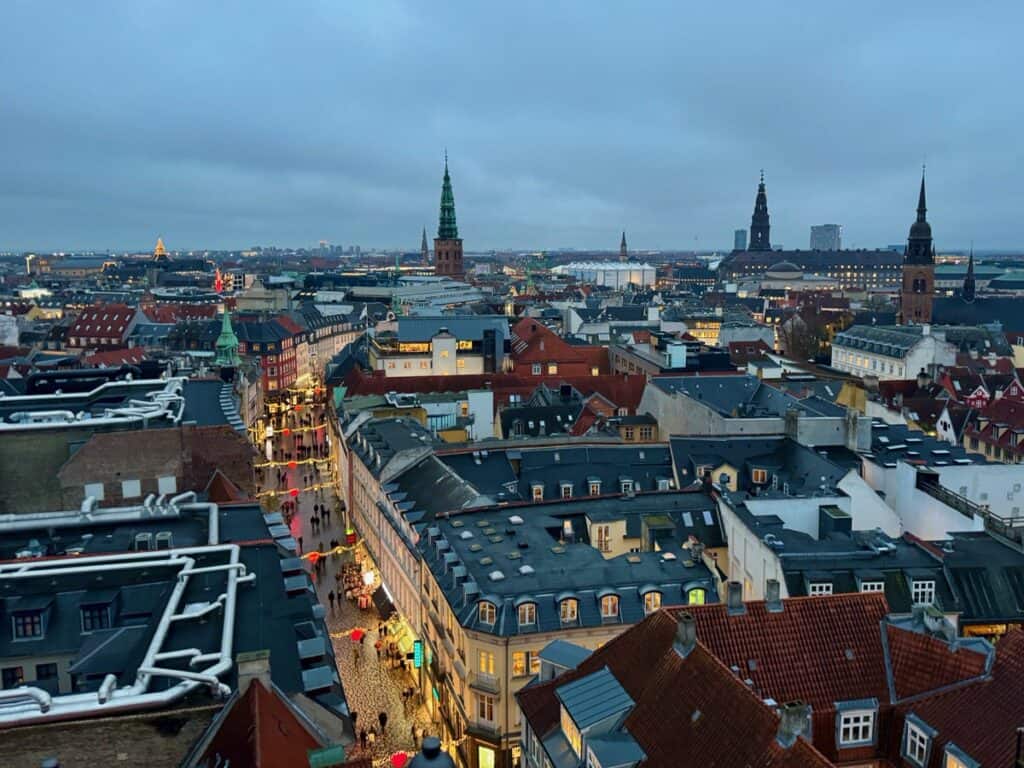 Central Copenhagen as seen from above at sunset as building lights come on in winter.