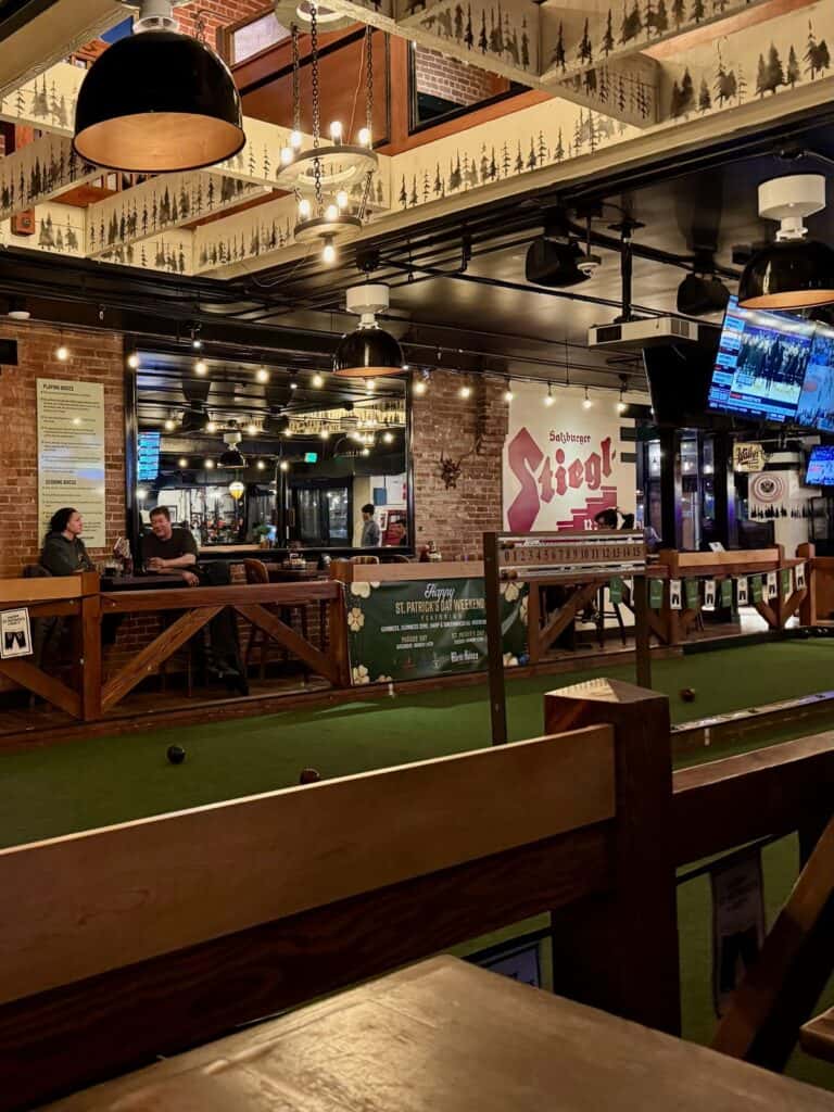 A turf covered bocce ball court inside a bar
