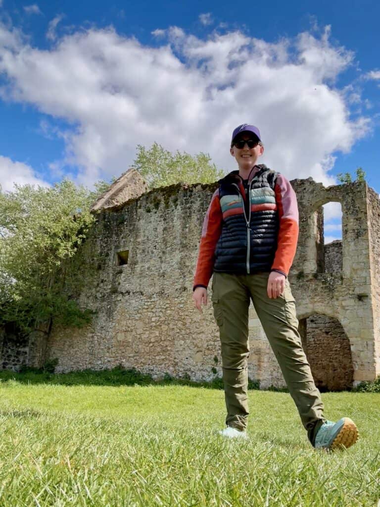 Woman poses in front of abbey ruins in Oxfordshire