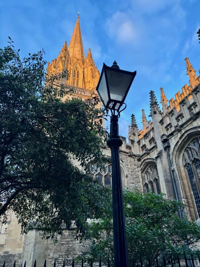 Spire of University Church of St. Mary the Virgin and Narnia Lamppost on St. Mary's Passage in Oxford.
