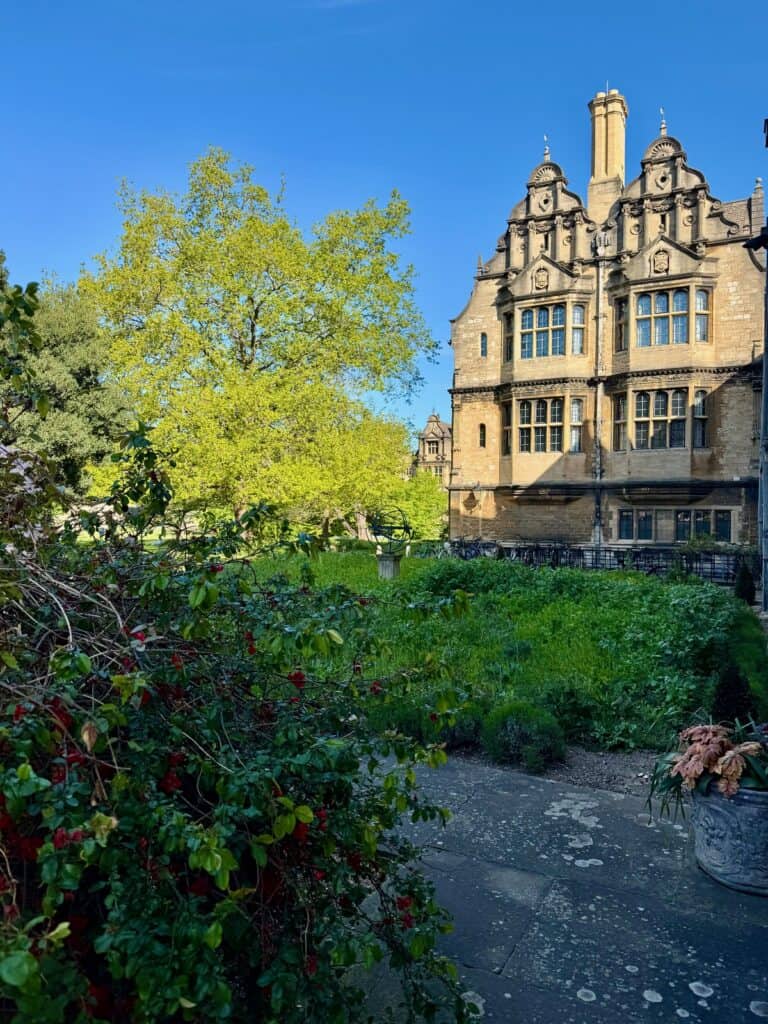 Looking into a garden in front of an Oxford porter lodge